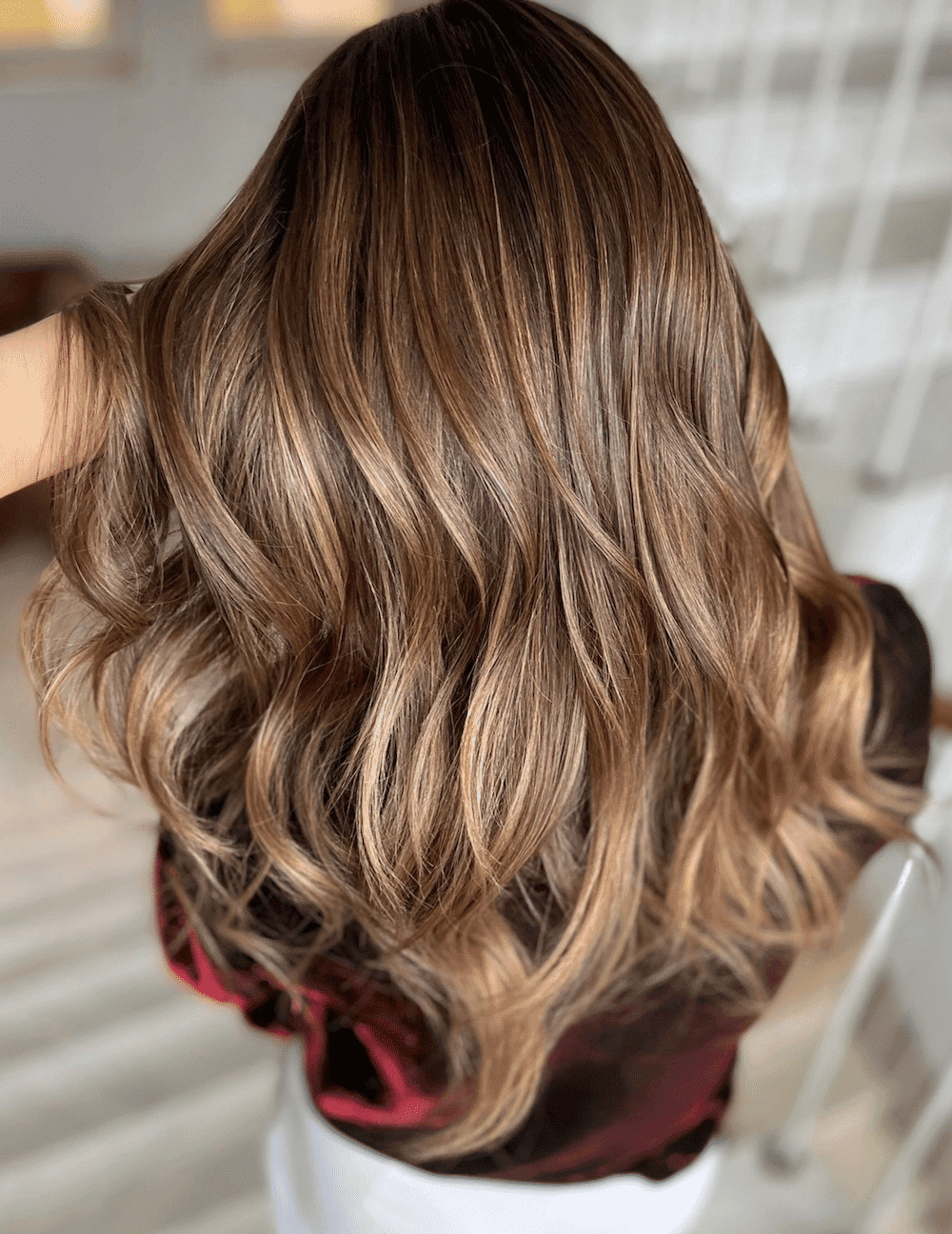 Woman's hair with brown to blonde ombre highlights.